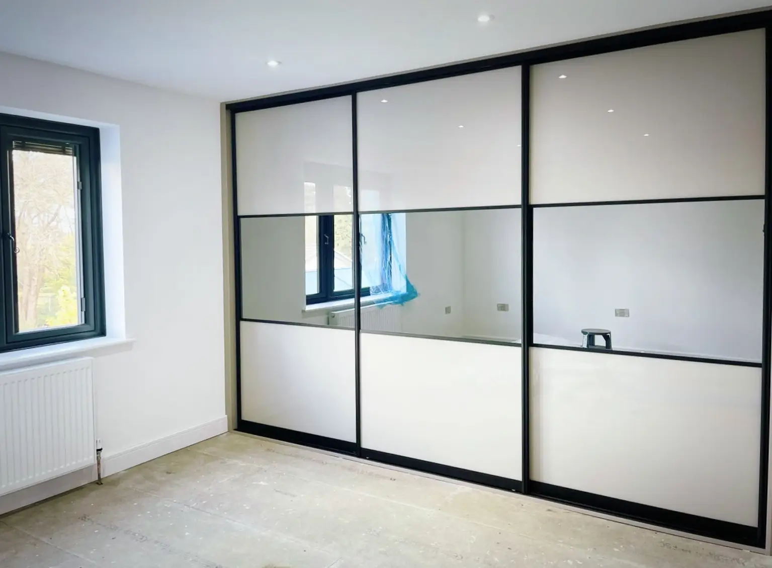 Sliding wardrobe with mirror middle section